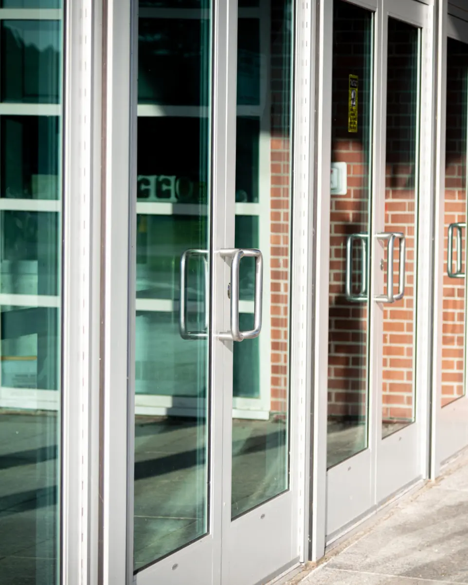 Four glass doors beside each other on the outside of a building